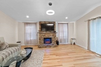 15 Ancona Road, Unit 1 Worcester, MA 01604 - Photo 2 of 11 a spacious bedroom with a bed and a flat screen tv