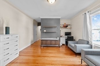 15 Ancona Road, Unit 1 Worcester, MA 01604 - Photo 7 of 11 a living room with furniture and a wooden floor