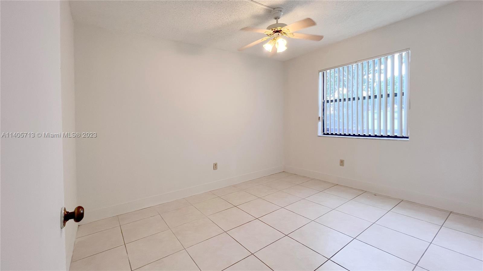 The Hammocks Miami, FL 33196 - Photo 11 of 20 an empty room with windows and fan