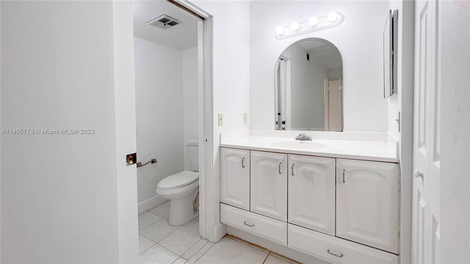 The Hammocks Miami, FL 33196 - Photo 15 of 20 a bathroom with a toilet sink and mirror