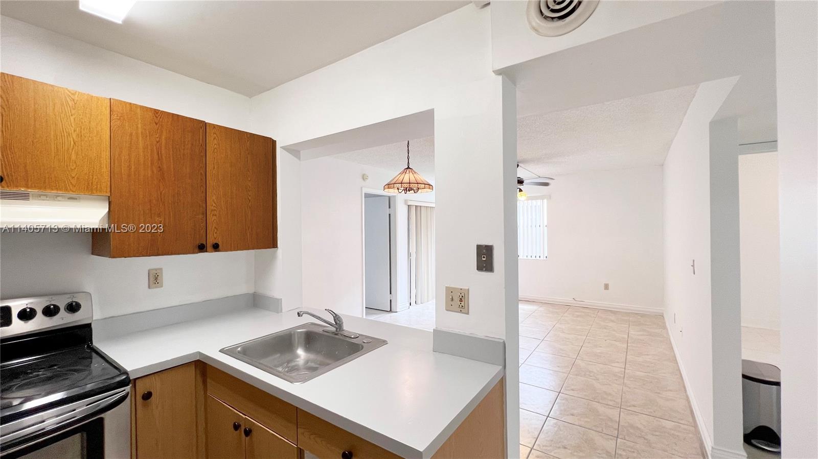 The Hammocks Miami, FL 33196 - Photo 10 of 20 a kitchen with a sink stove and cabinets
