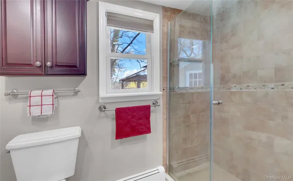 a bathroom with a toilet and a shower