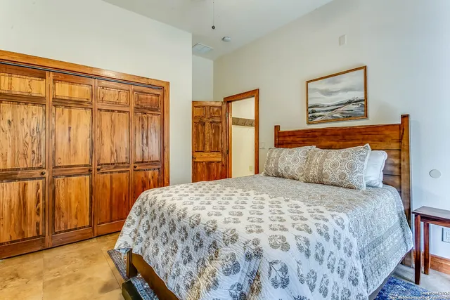 a bedroom with a large bed and a window