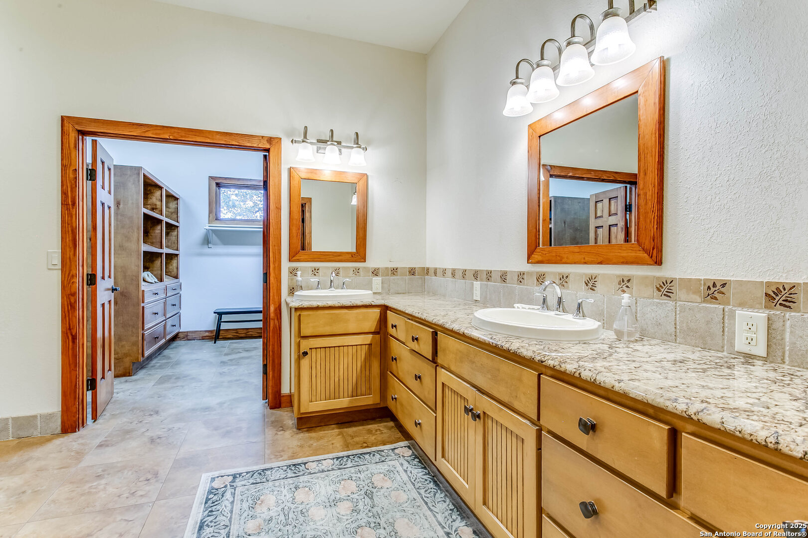 408 Copeland Hill Road Smithville, TX 78957 - Photo 19 of 35 a bathroom with a granite countertop sink and a mirror