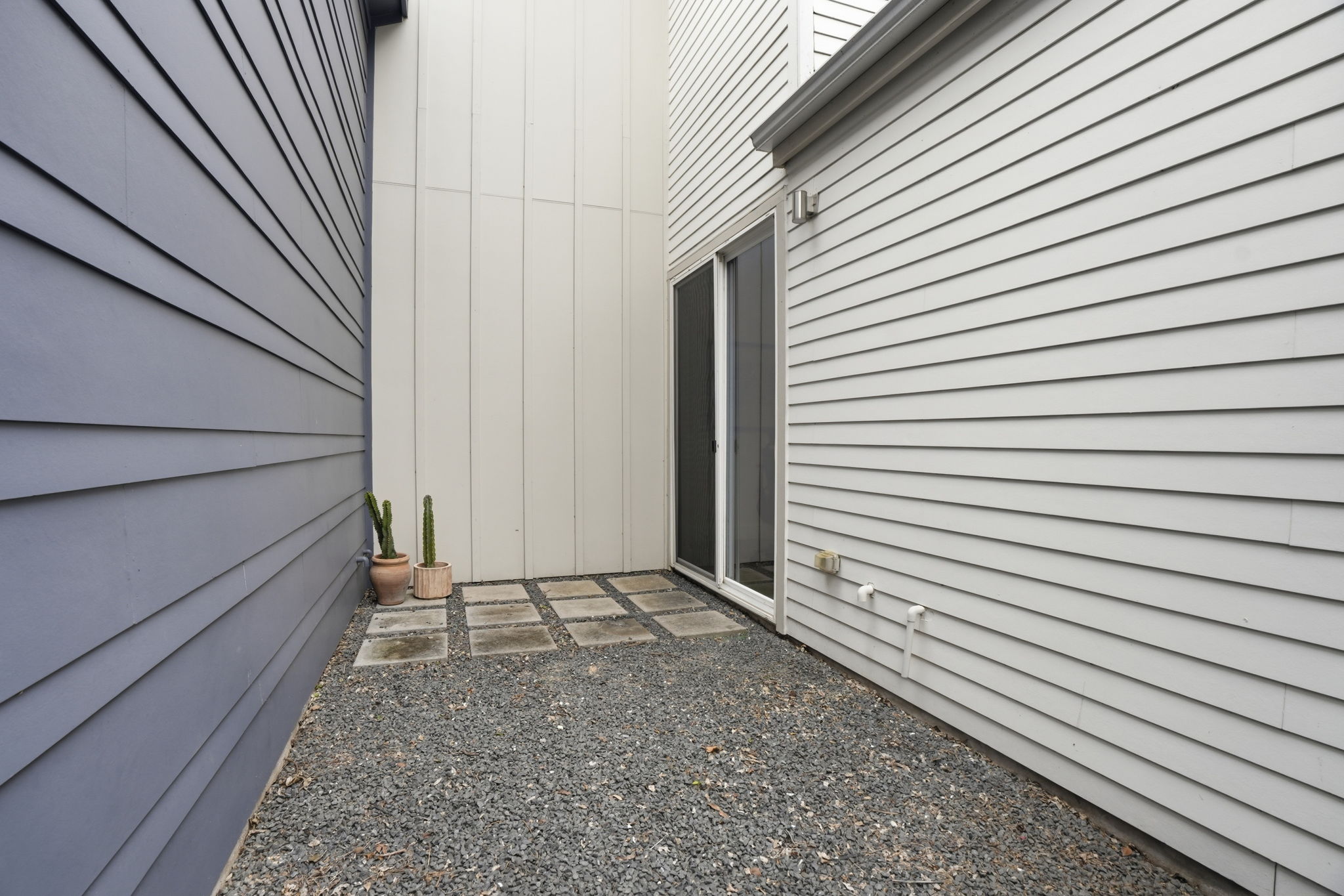 4609 Sara Drive, Unit B Austin, TX 78721 - Photo 10 of 39 A secluded patio with gravel and pavers offers a private outdoor retreat from the home office.