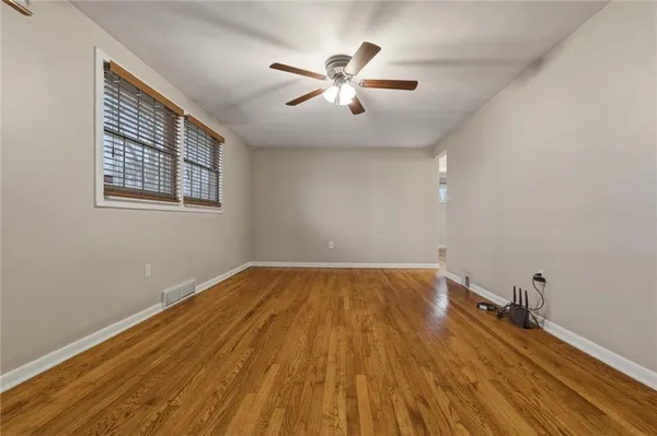 wooden floor in an empty room with a window