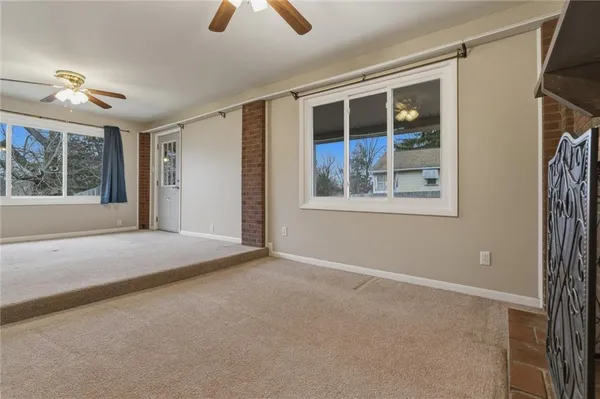 an empty room with windows and entrance