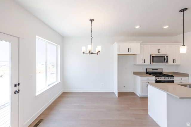 5224 South Acacia Drive, Unit 809 Mapleton, UT 84664 - Photo 8 of 23 Open concept kitchen and dining area featuring light wood-finish flooring
