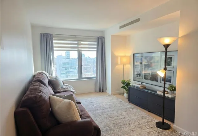 a living room with furniture and a large window