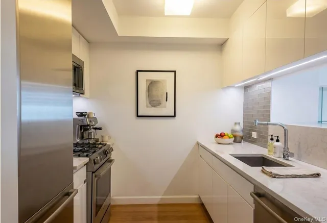 a kitchen that has a sink and a stove top oven