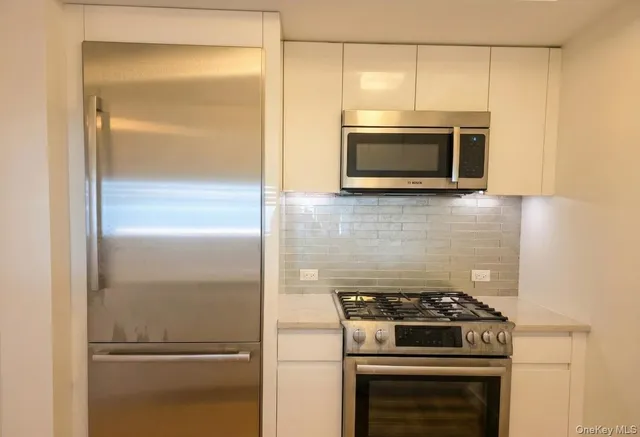 a kitchen with a refrigerator stove and microwave