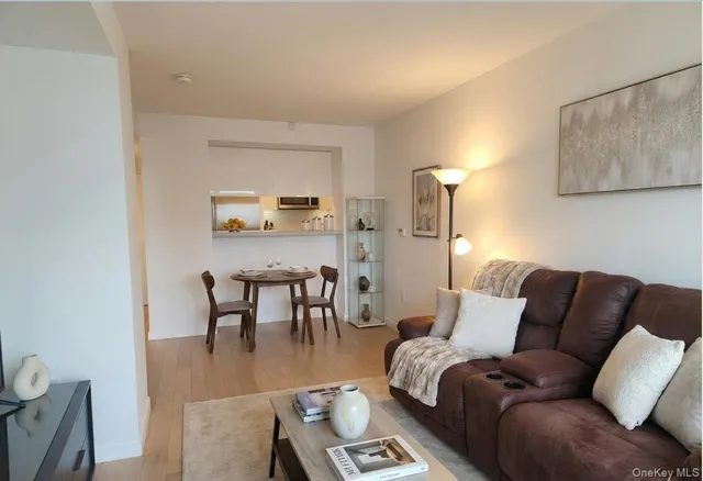 a living room with furniture and a dining table