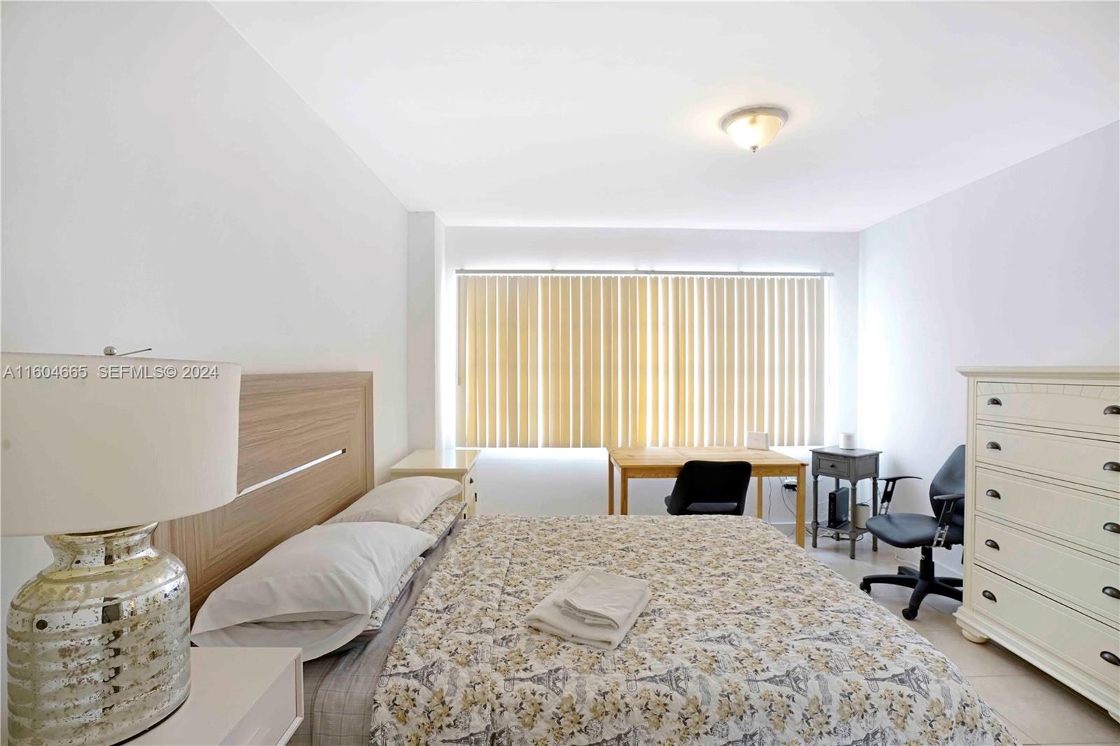 624 Northwest 11th Street Miami, FL 33136 - Photo 11 of 26 a bedroom with a bed and window