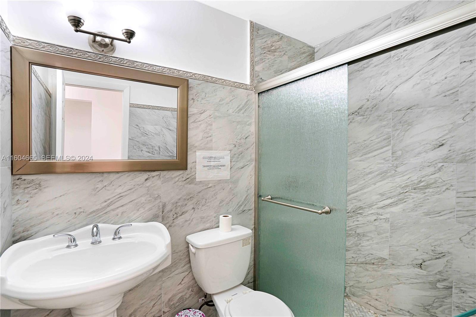 624 Northwest 11th Street Miami, FL 33136 - Photo 15 of 26 a bathroom with a toilet sink and a mirror