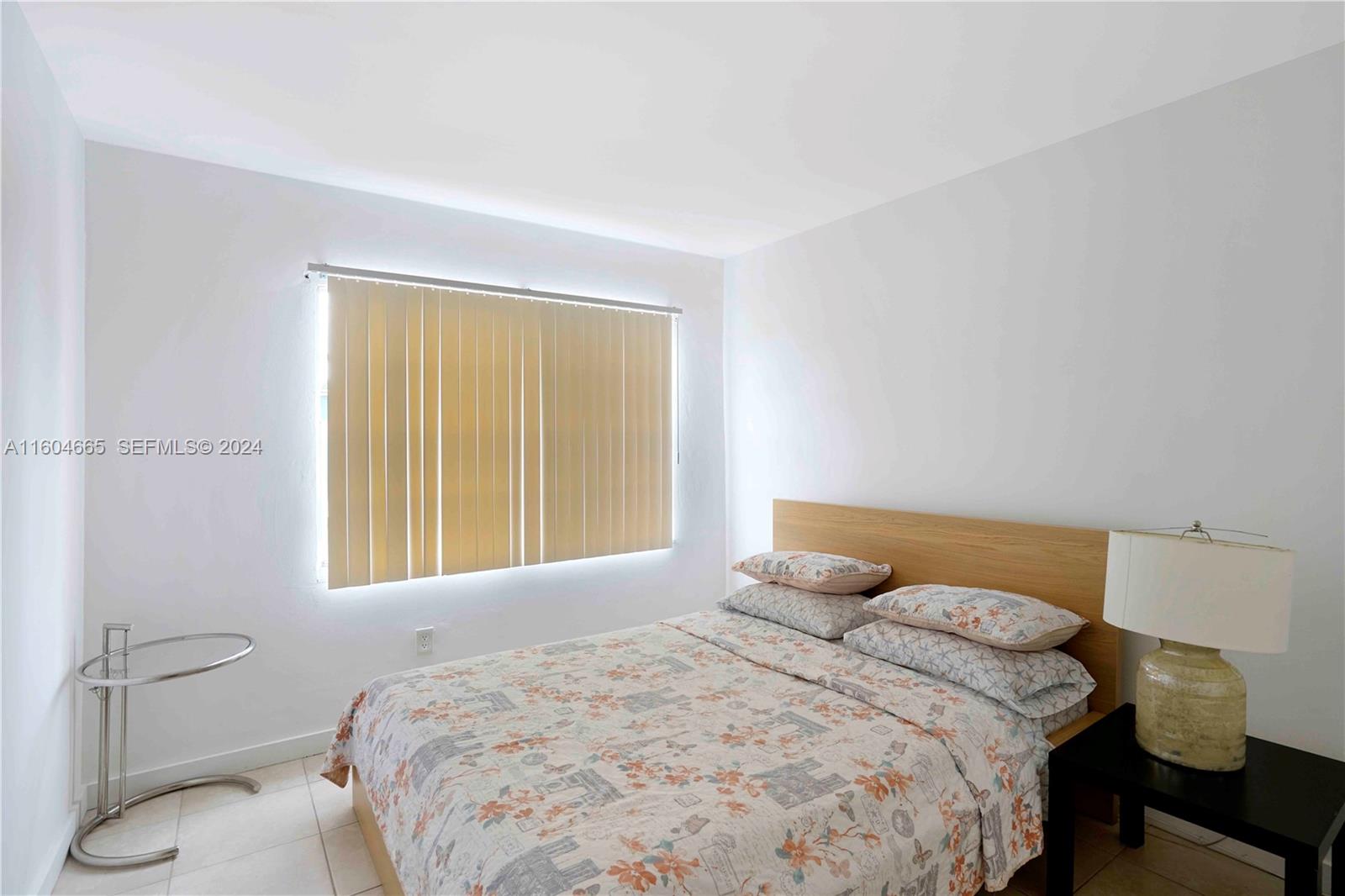 624 Northwest 11th Street Miami, FL 33136 - Photo 17 of 26 a bedroom with a bed and window