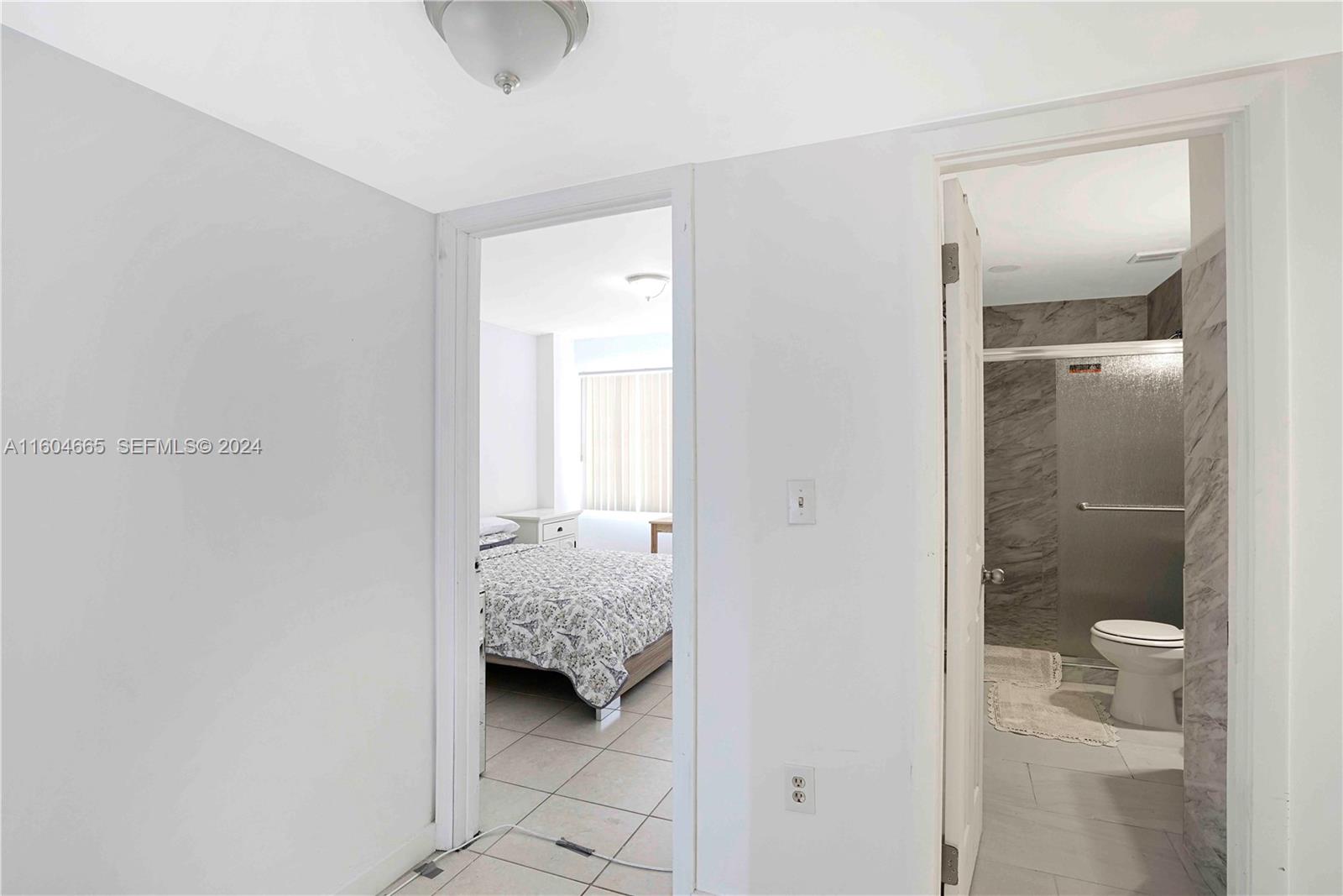 624 Northwest 11th Street Miami, FL 33136 - Photo 19 of 26 a en suite bathroom with a granite countertop sink and a mirror