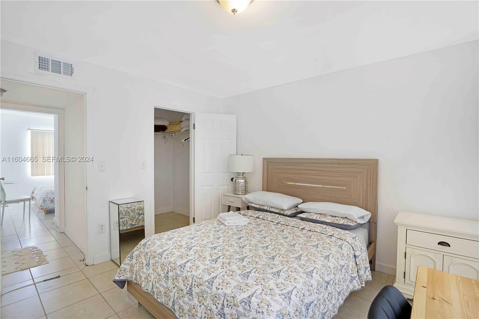 624 Northwest 11th Street Miami, FL 33136 - Photo 21 of 26 a bedroom with a bed and a view of bathroom