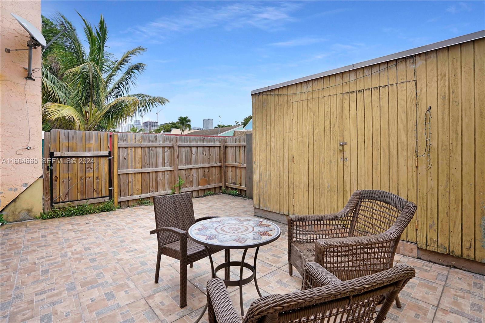 624 Northwest 11th Street Miami, FL 33136 - Photo 24 of 26 a backyard of a house with table and chairs