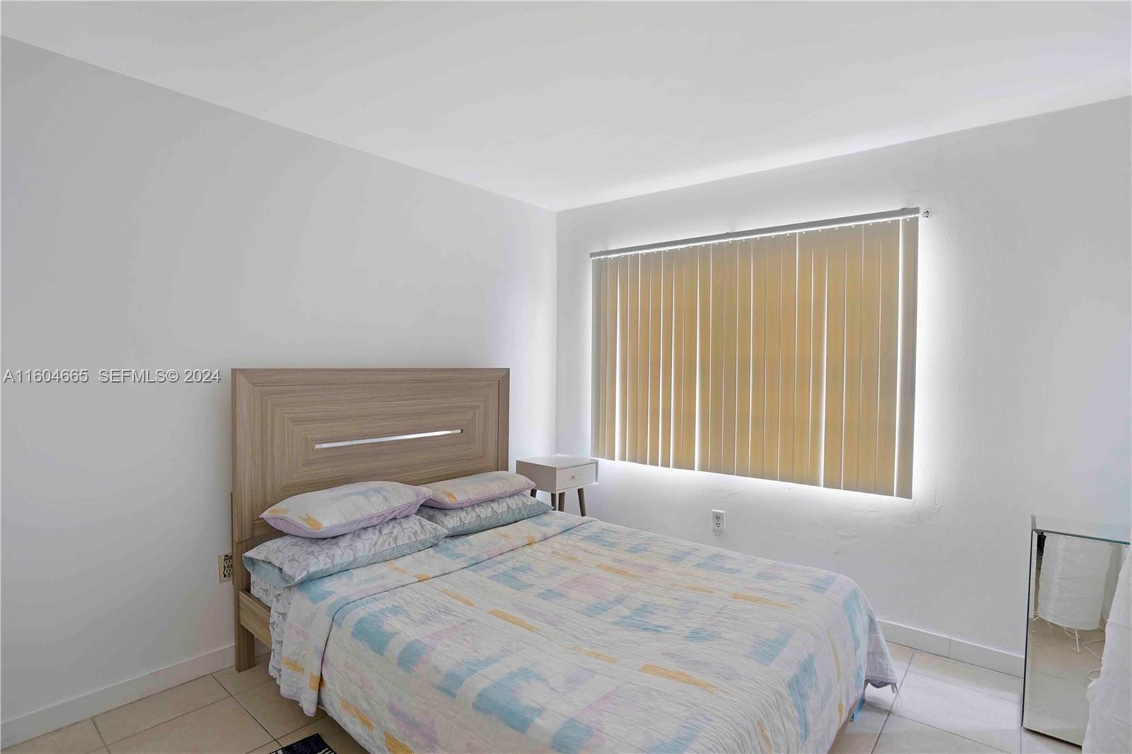624 Northwest 11th Street Miami, FL 33136 - Photo 5 of 26 a bedroom with a bed and a window