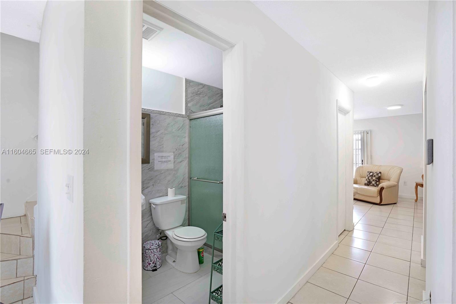 624 Northwest 11th Street Miami, FL 33136 - Photo 6 of 26 a bathroom with a granite countertop toilet and a shower