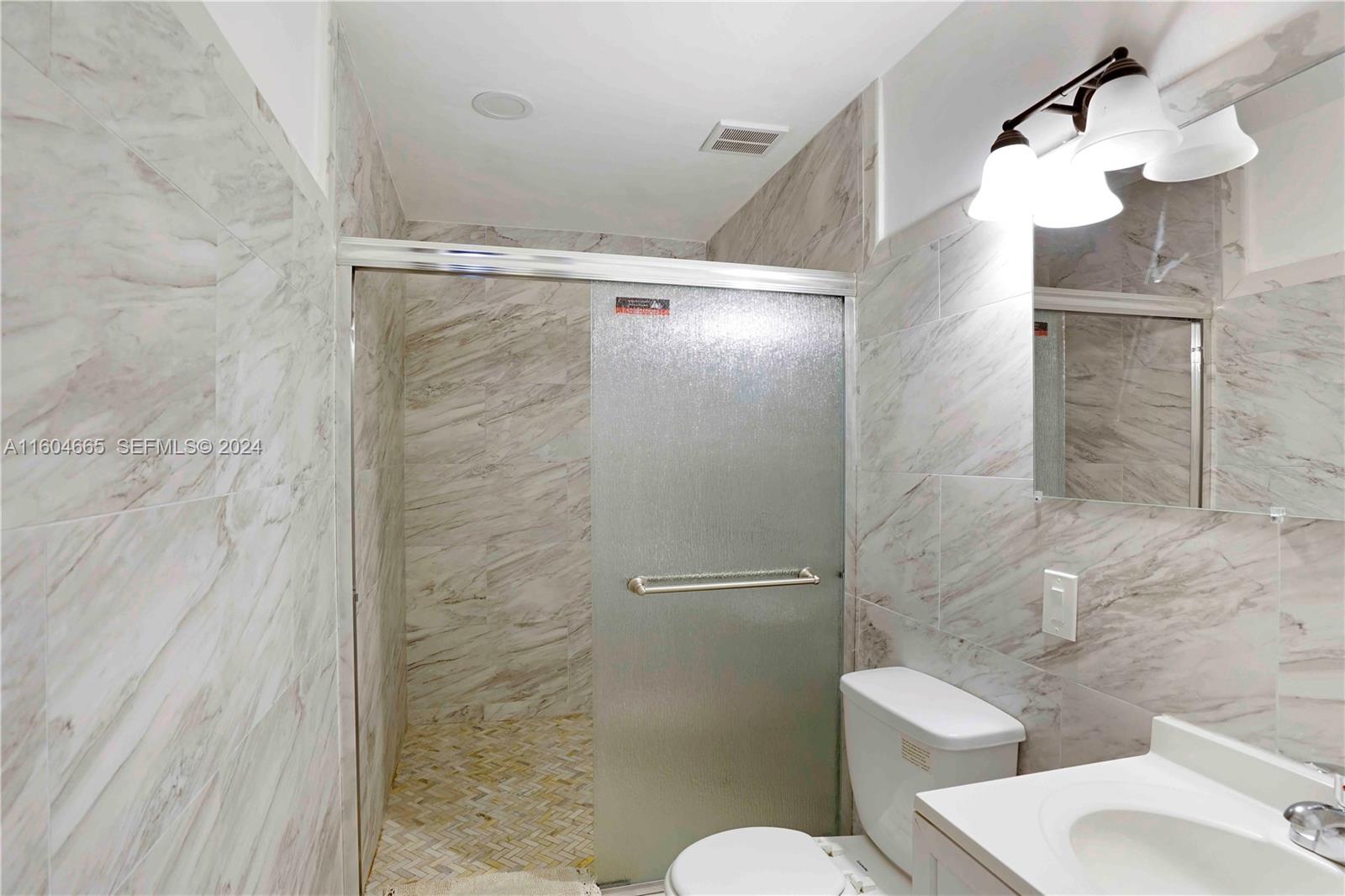 624 Northwest 11th Street Miami, FL 33136 - Photo 9 of 26 a bathroom with a toilet and a shower