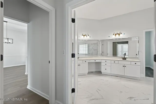 a bathroom with a sink double vanity and a tub