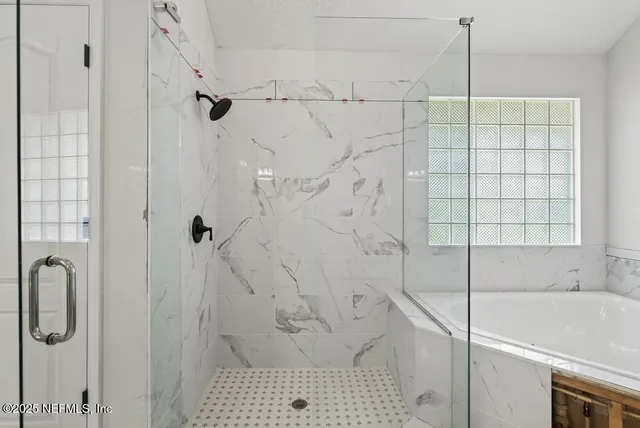 a spacious bathroom with a shower sink and mirror
