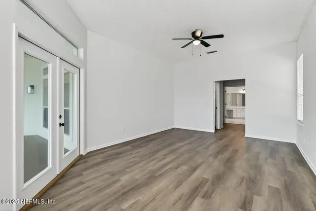 a view of wooden floor and windows in a room