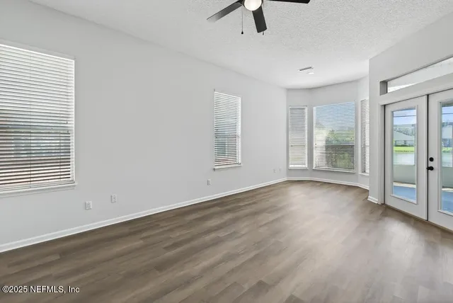 a view of a kitchen with a sink wooden floor and a window