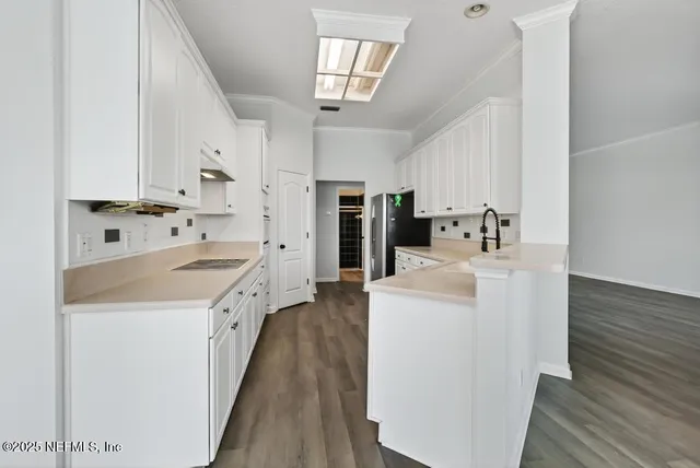 a view of an empty room with a floor to ceiling windows