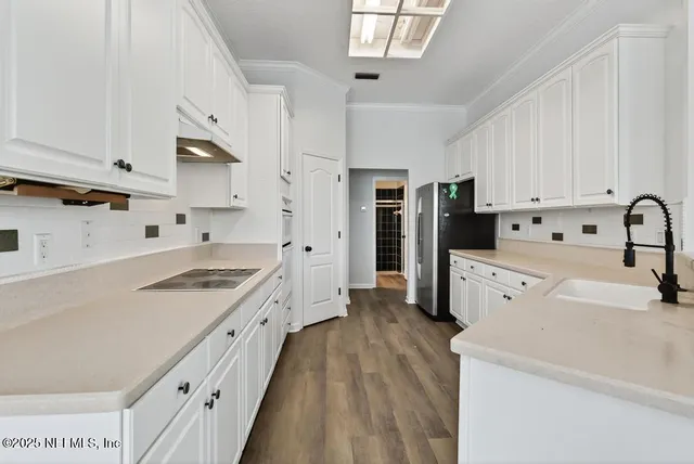 an aerial view of a house with a yard and potted plants