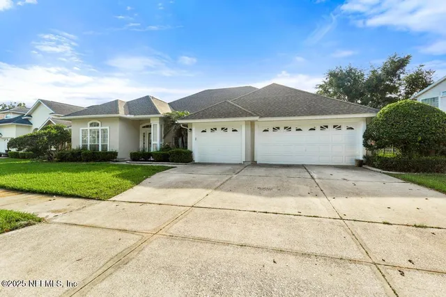 a view of a hallway with wooden floor and a bathroom