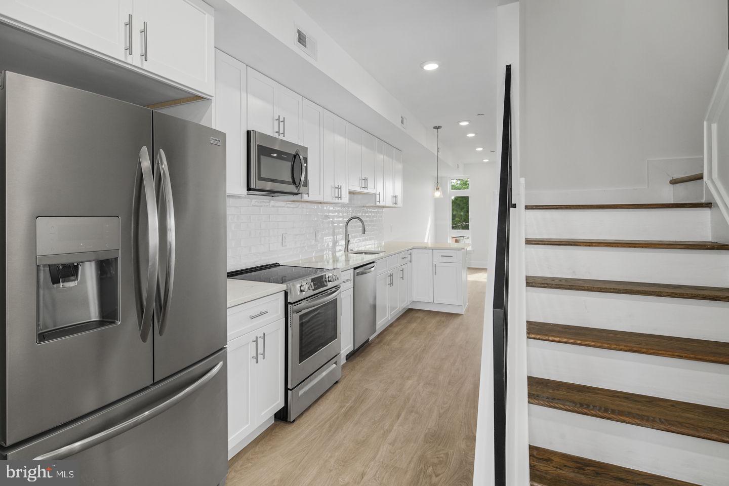 2721 Federal Street, Unit 3 Philadelphia, PA 19146 - Photo 1 of 22 a kitchen with stainless steel appliances granite countertop a refrigerator a sink and a stove