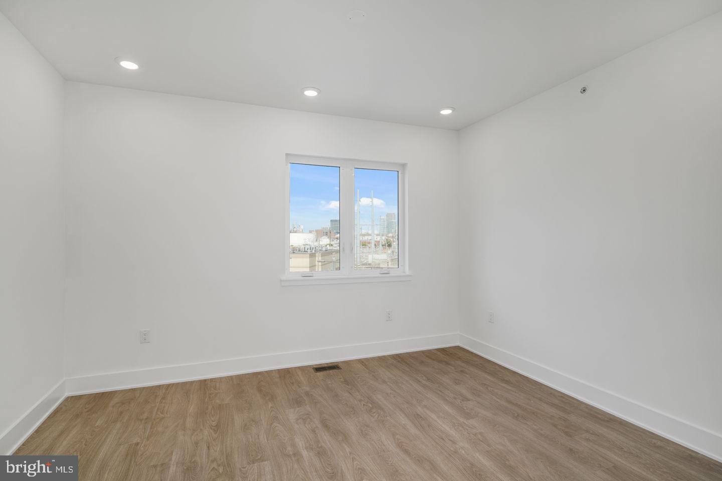 2721 Federal Street, Unit 3 Philadelphia, PA 19146 - Photo 11 of 22 a view of an empty room with wooden floor and a window