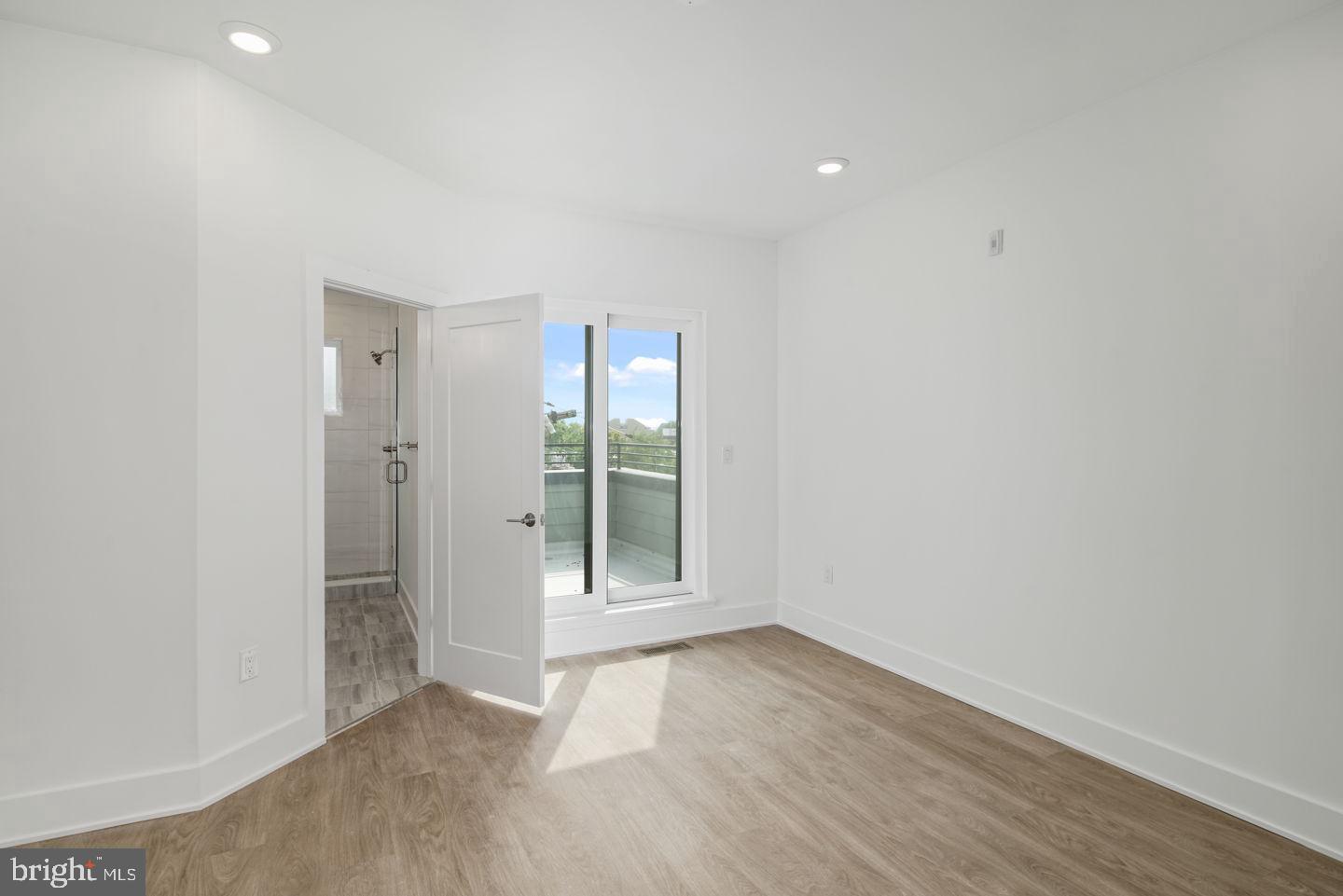 2721 Federal Street, Unit 3 Philadelphia, PA 19146 - Photo 14 of 22 an empty room with wooden floor and sliding door