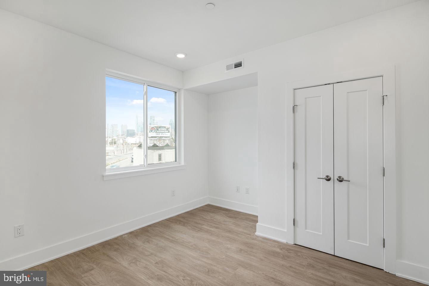 2721 Federal Street, Unit 3 Philadelphia, PA 19146 - Photo 8 of 22 an empty room with wooden floor and a window
