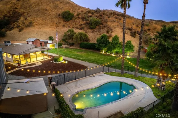 a view of a swimming pool with a yard