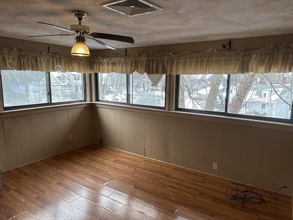 101 Hackensack Road Boston, MA 02467 - Photo 12 of 33 a view of empty room with wooden floor and fan
