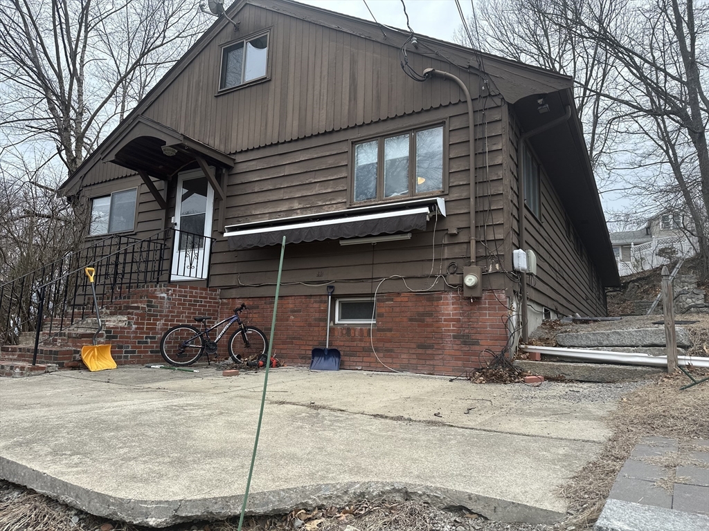 101 Hackensack Road Boston, MA 02467 - Photo 2 of 33 a front view of a house with parking area