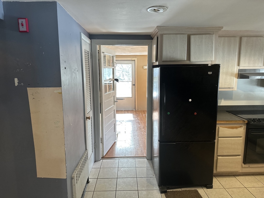 101 Hackensack Road Boston, MA 02467 - Photo 21 of 33 a kitchen with a refrigerator and cabinets