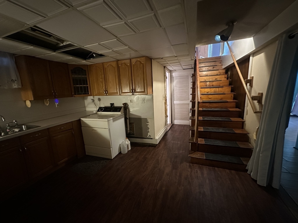101 Hackensack Road Boston, MA 02467 - Photo 24 of 33 a kitchen with a sink a refrigerator and cabinets
