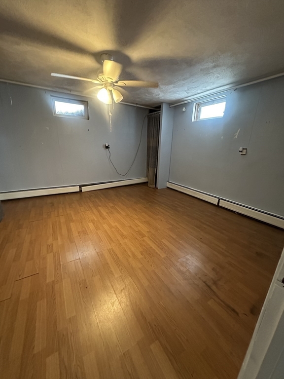 101 Hackensack Road Boston, MA 02467 - Photo 27 of 33 a view of an empty room with wooden floor