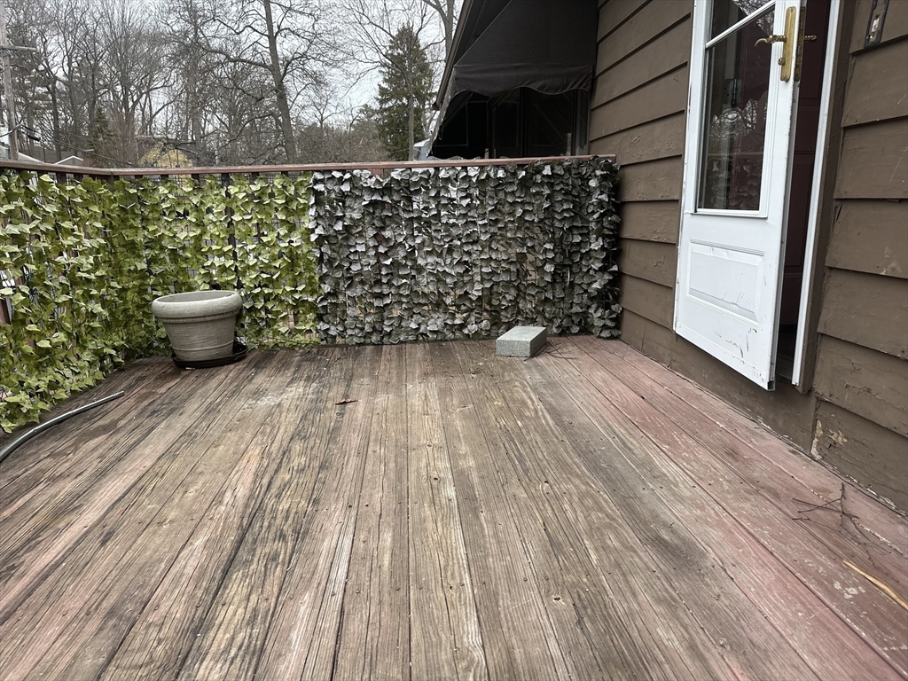 101 Hackensack Road Boston, MA 02467 - Photo 31 of 33 a view of a room with wooden floor and a bench