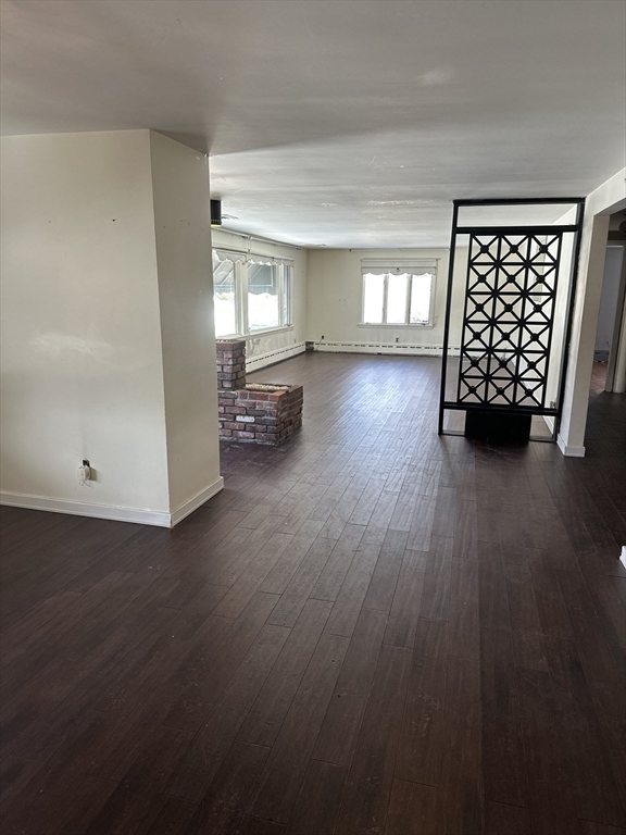 101 Hackensack Road Boston, MA 02467 - Photo 5 of 33 a view of an empty room with wooden floor and windows