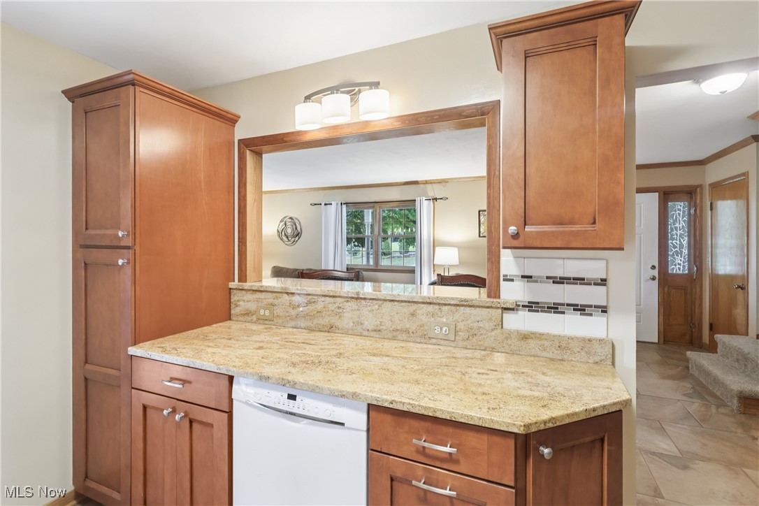 520 East Caston Road Uniontown, OH 44685 - Photo 14 of 47 Kitchen with white dishwasher, granite counterops and cupboards