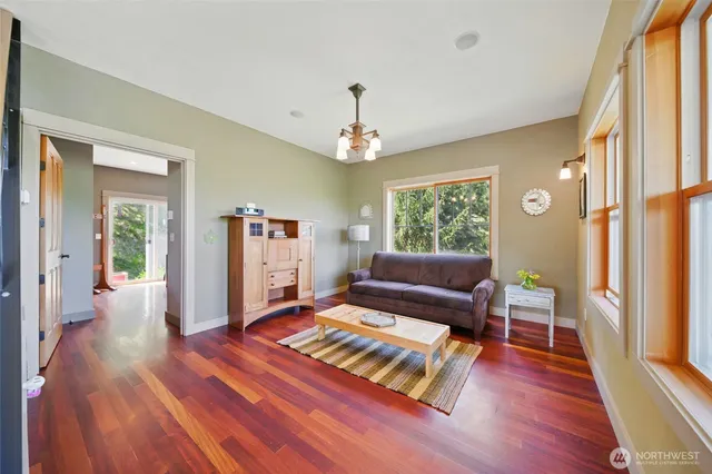 a living room with furniture and a chandelier