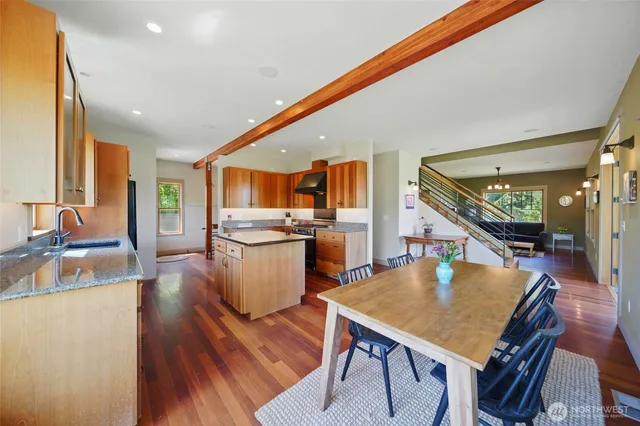 a kitchen with a table chairs and wooden floor
