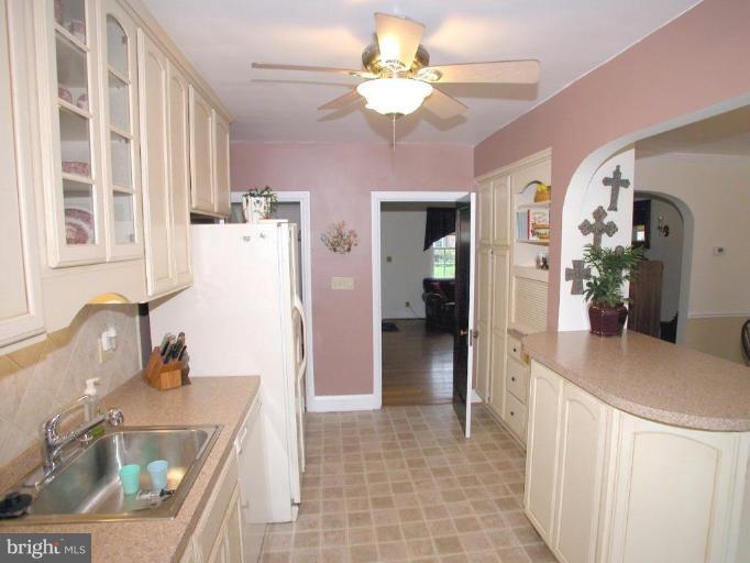 316 Murdock Road Baltimore, MD 21212 - Photo 11 of 25 a kitchen with stainless steel appliances granite countertop a sink and a refrigerator
