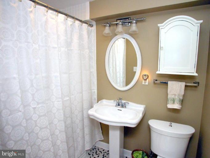316 Murdock Road Baltimore, MD 21212 - Photo 14 of 25 a bathroom with a sink and a mirror