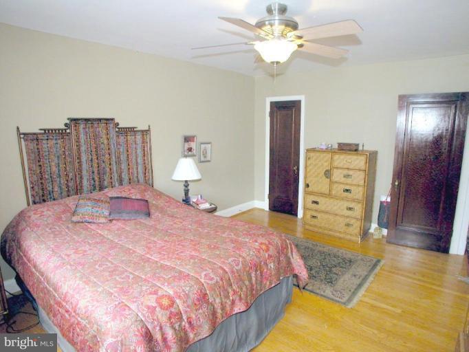 316 Murdock Road Baltimore, MD 21212 - Photo 15 of 25 a bed room with a bed and a chandelier
